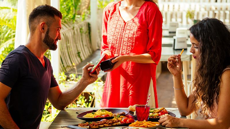 couple paying for meal in restaurant